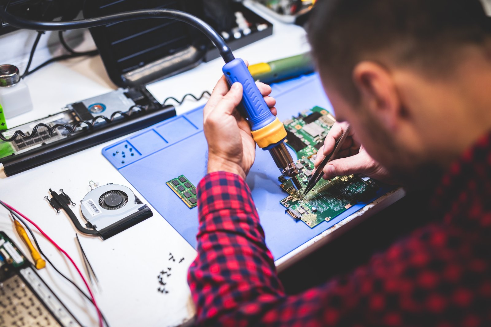 Home 3 man repairing laptop at workplace