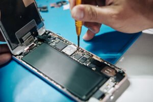Why Is My Iphone Overheating? Causes, Fixes And When To Get Help 2 fixing a smartphone with a screwdriver 2026 01 08 00 10 03 utc