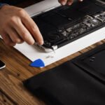 laptop repair on wooden table with toolkit 2026 09 24 02 47 11 utc