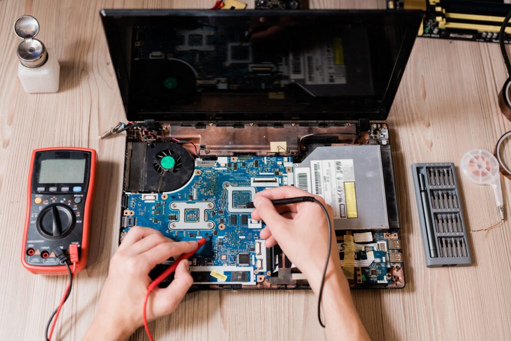 Virus, Spyware, Antivirus — What To Do When Your Laptop Gets Infected And How To Stay Protected 2 laptop repair with multimeter on wooden table 2026 09 22 02 59 48 utc